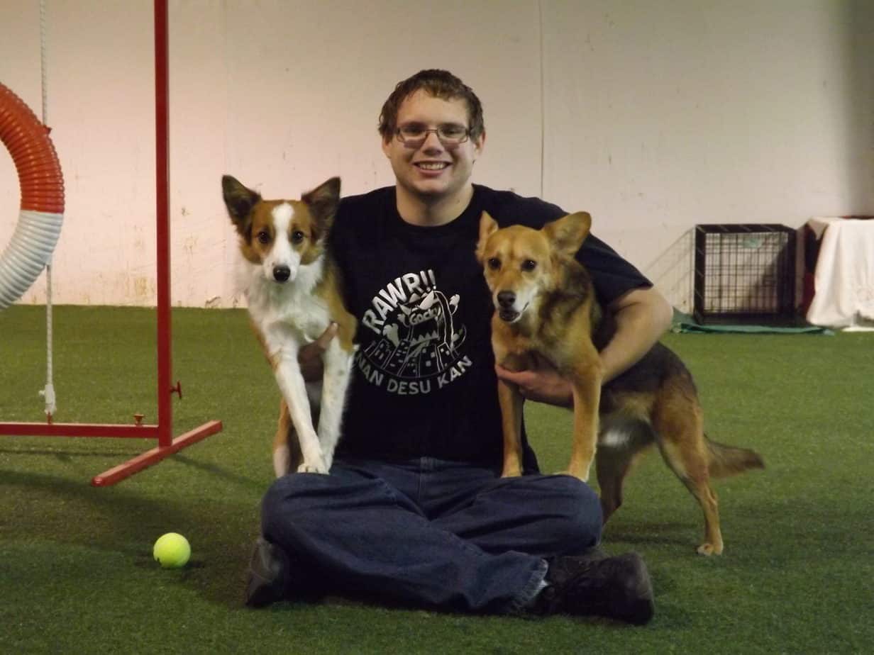 Young man with two agility dogs